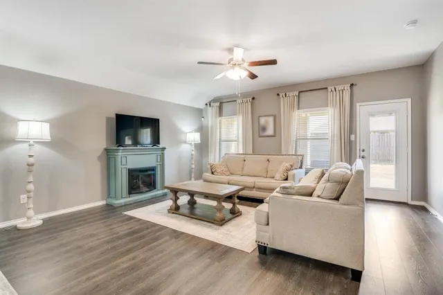 a living room with furniture fireplace and flat screen tv