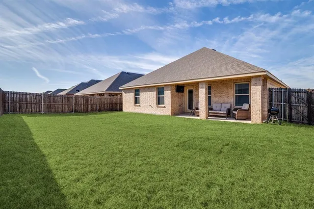 a view of a house with a yard and porch