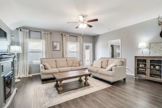 a living room with furniture and a fireplace