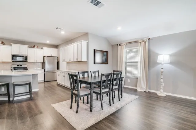 a view of a dining room with furniture and wooden floor