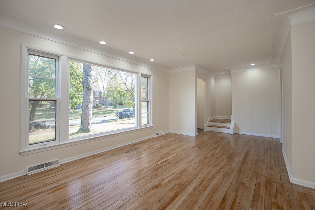 3136 Becket Road Cleveland, OH 44120 - Photo 12 of 39 Spare room featuring crown molding and light hardwood / wood-style flooring