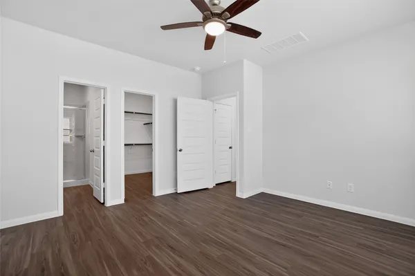 a view of empty room with wooden floor
