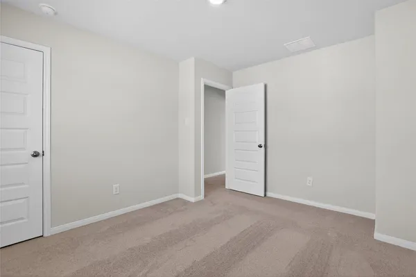 an empty room with an entrance to other room