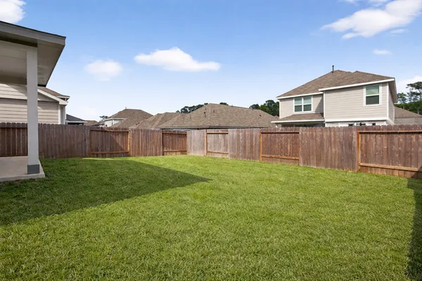 a view of a backyard with a garden and entertaining space