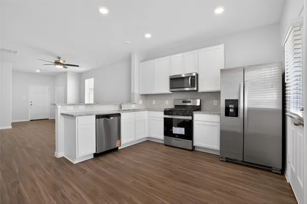a kitchen with a refrigerator and a sink