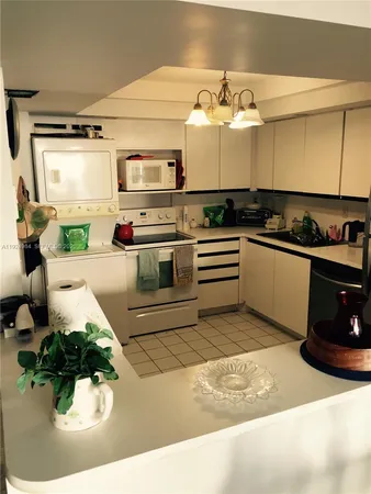 a kitchen with stainless steel appliances kitchen island granite countertop a sink and cabinets