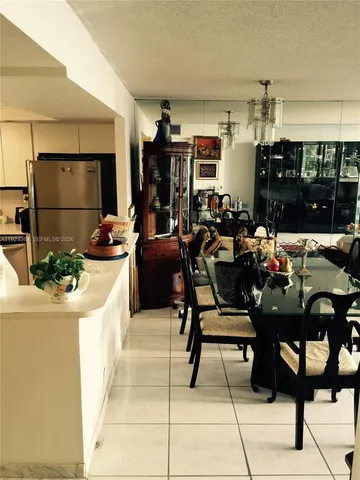 a living room with lots of furniture and clutter