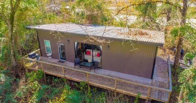 view of house with balcony and outdoor seating