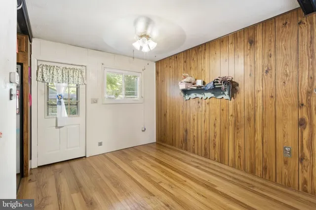 a view of a room with a window and wooden floor