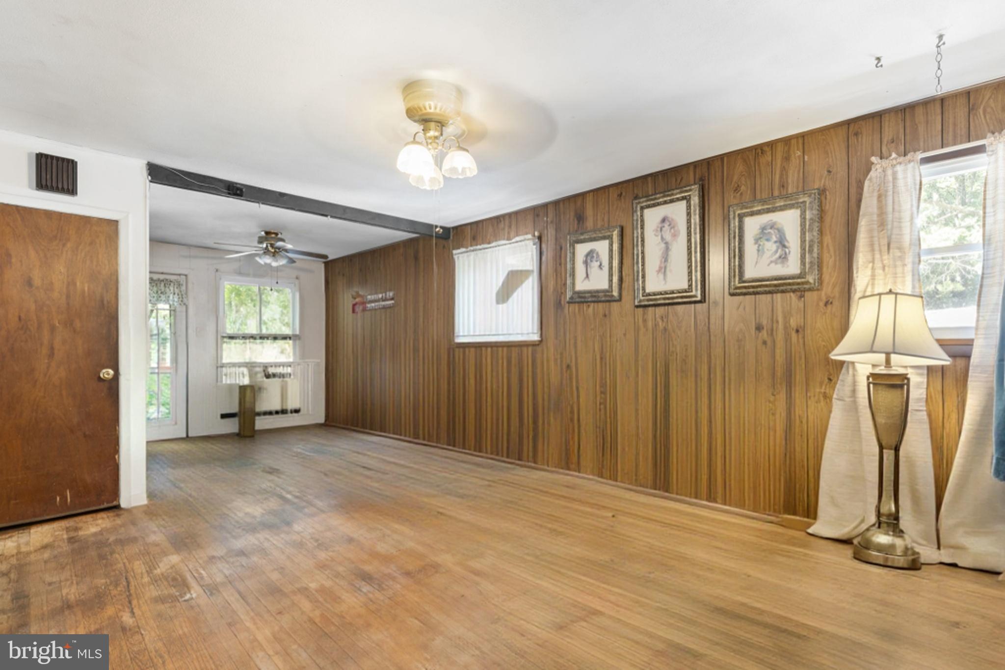 52 Carol Lane Malvern, PA 19355 - Photo 2 of 14 a view of empty room with wooden floor and fan