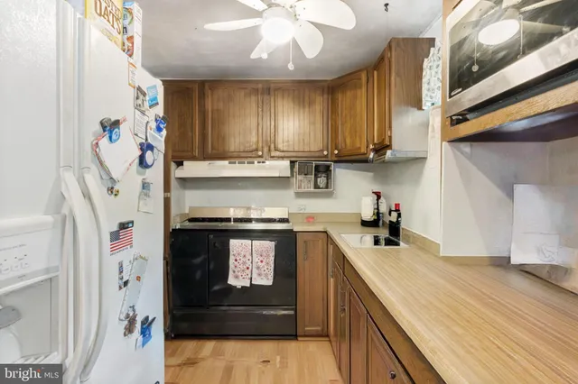 a kitchen with stainless steel appliances granite countertop a stove and a sink