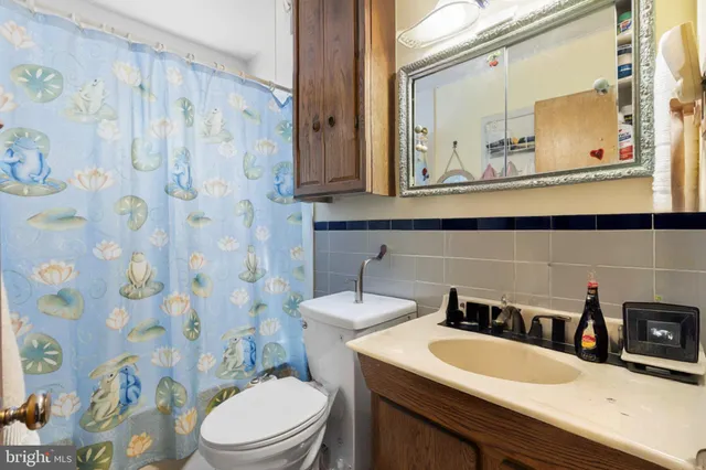 a bathroom with a toilet a sink and a mirror