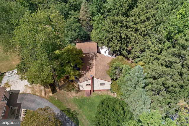 an aerial view of a house with a yard