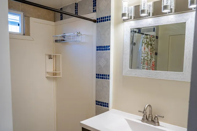 a bathroom with a sink and mirror