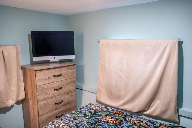 a room with a cabinet and a flat screen tv