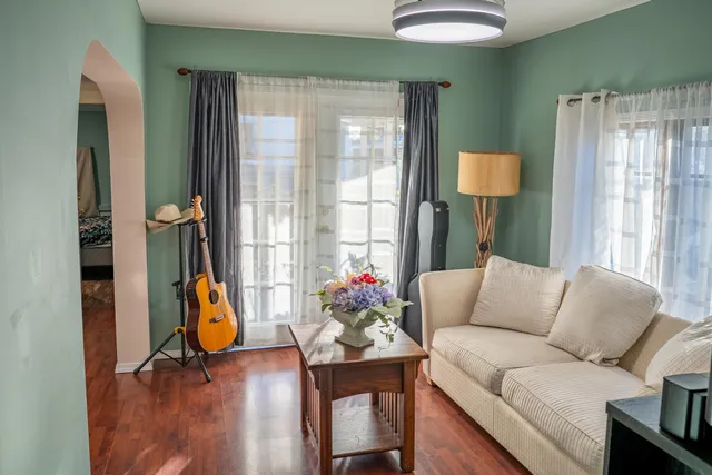 a living room with furniture and wooden floor
