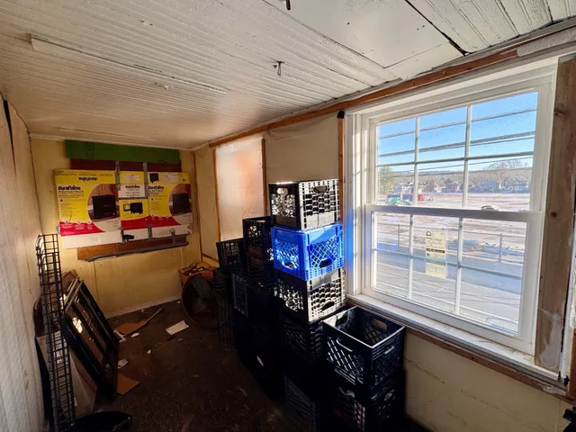 a room with furniture washer and a large window