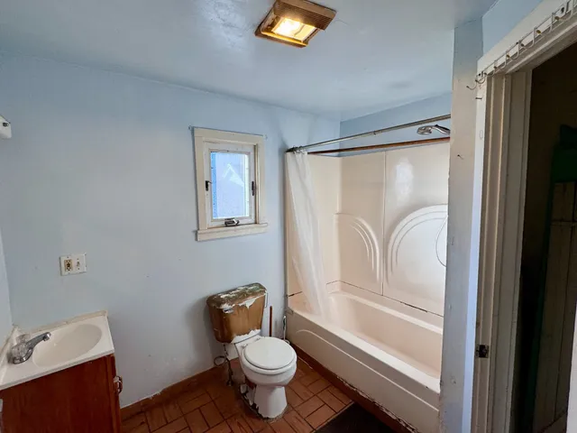 a white toilet sitting next to a bathroom sink