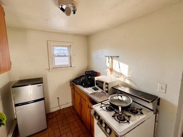 a stove top oven sitting inside of a kitchen