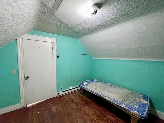 a bathroom with a granite countertop sink and a toilet