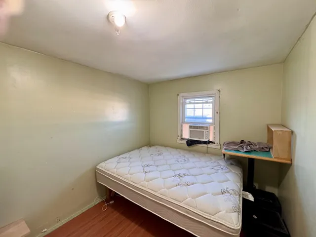 a bedroom with a bed and window