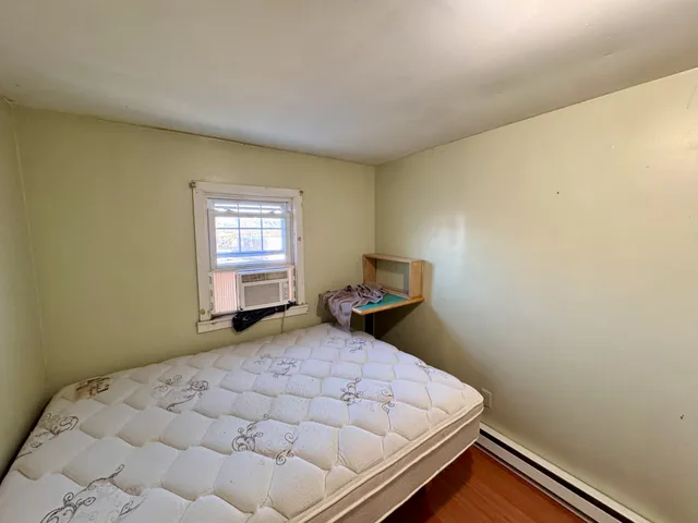 a bedroom with a bed and window
