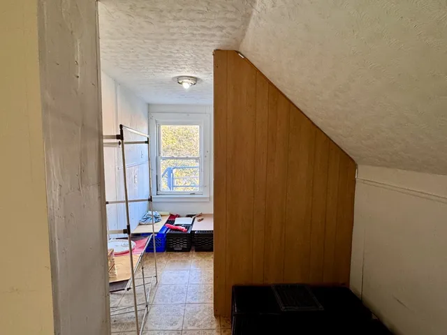 a view of a hallway with couch and closet