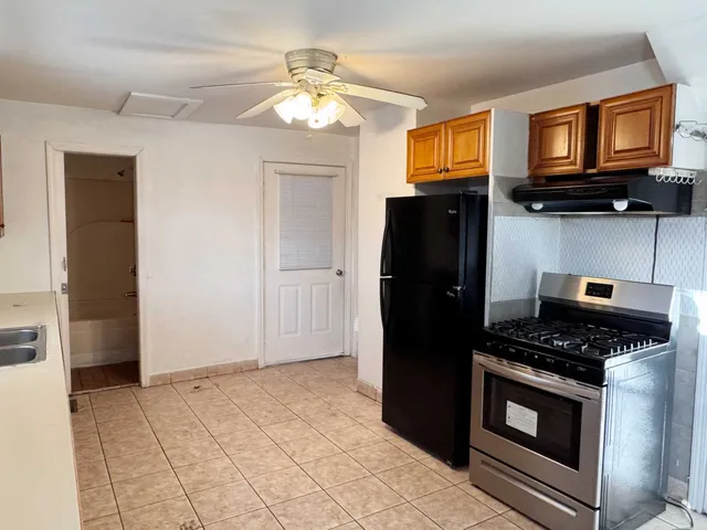 a kitchen with stainless steel appliances granite countertop a refrigerator stove and sink
