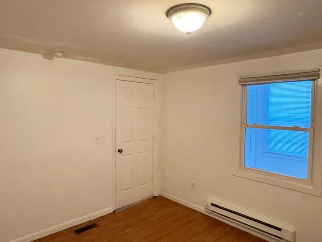 an empty room with a wooden door