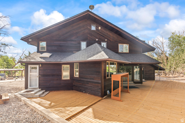 460 Omni Point Road Central Valley, UT 84754 - Photo 68 of 101 Multi-level dark-stained wood exterior featuring a spacious wood deck, multiple windows, and a dark shingled roof