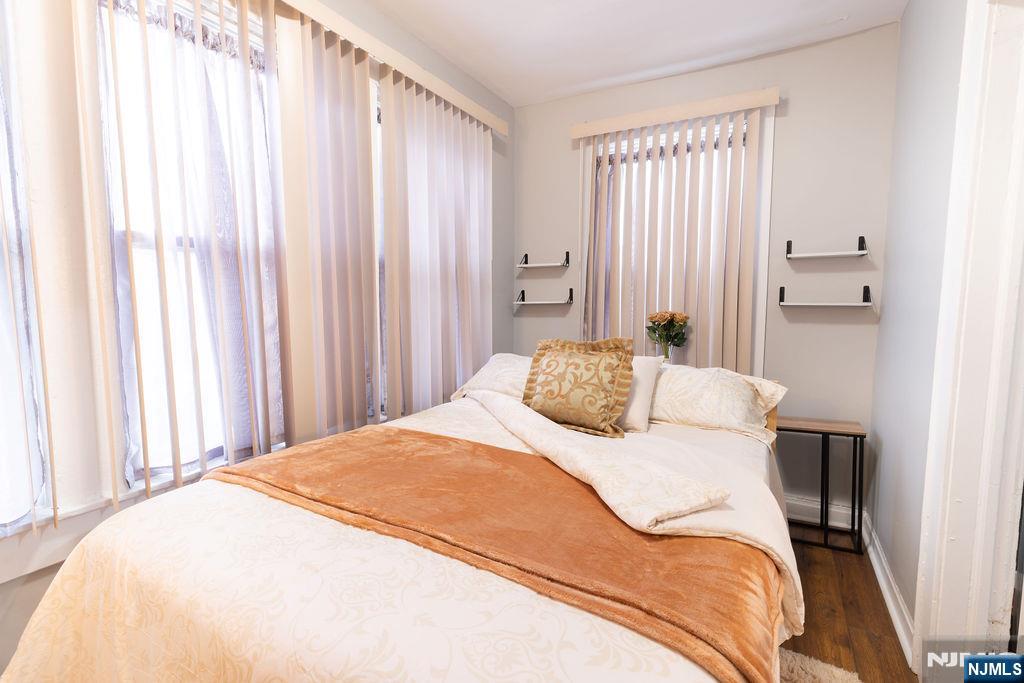 40-42 Harding Terrace Newark, NJ 07112 - Photo 3 of 15 a bedroom with a bed and curtain