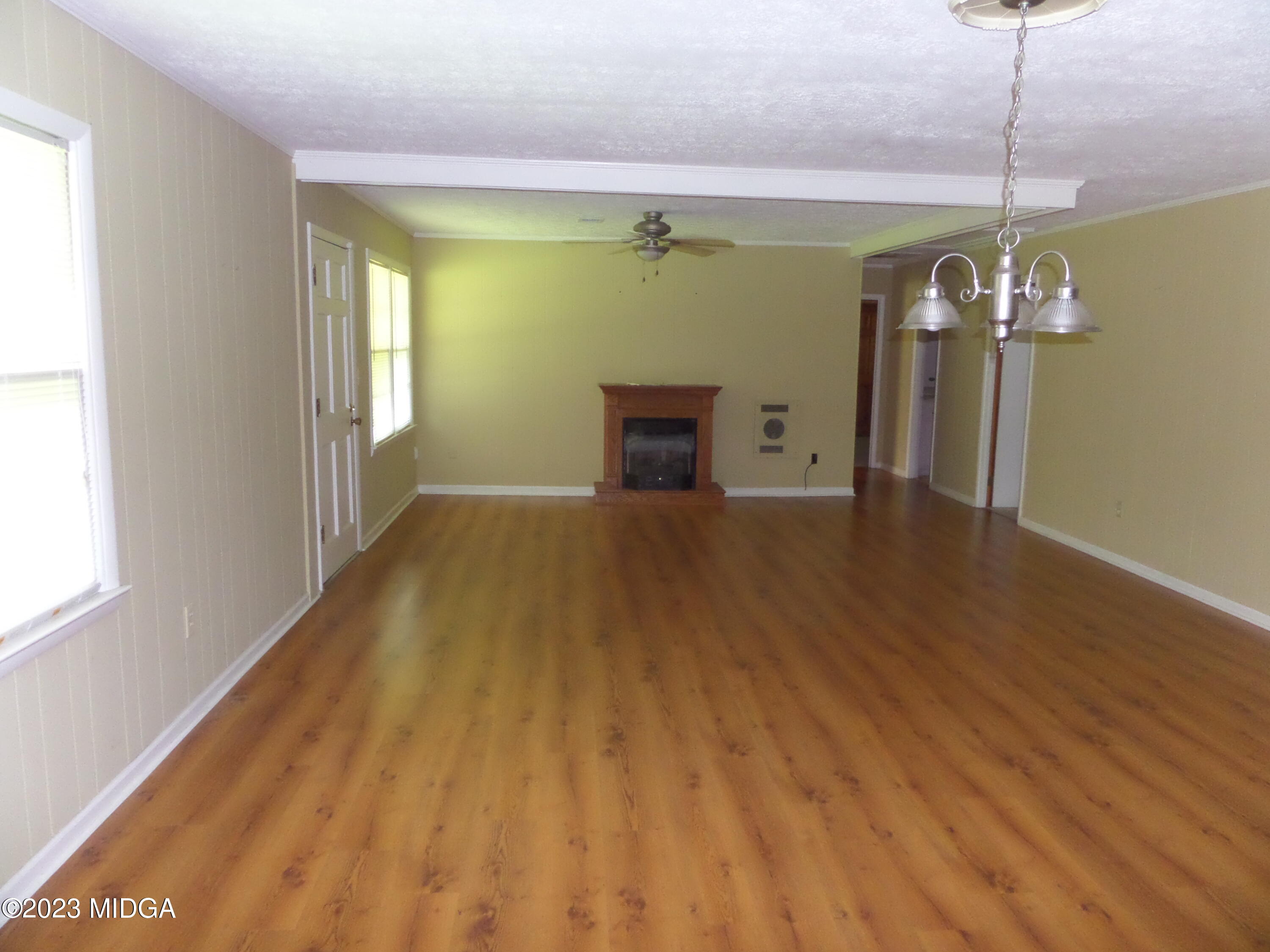 2816 Montpelier Station Road Musella, GA 31066 - Photo 2 of 9 a view of a room with wooden floor fireplace and staircase