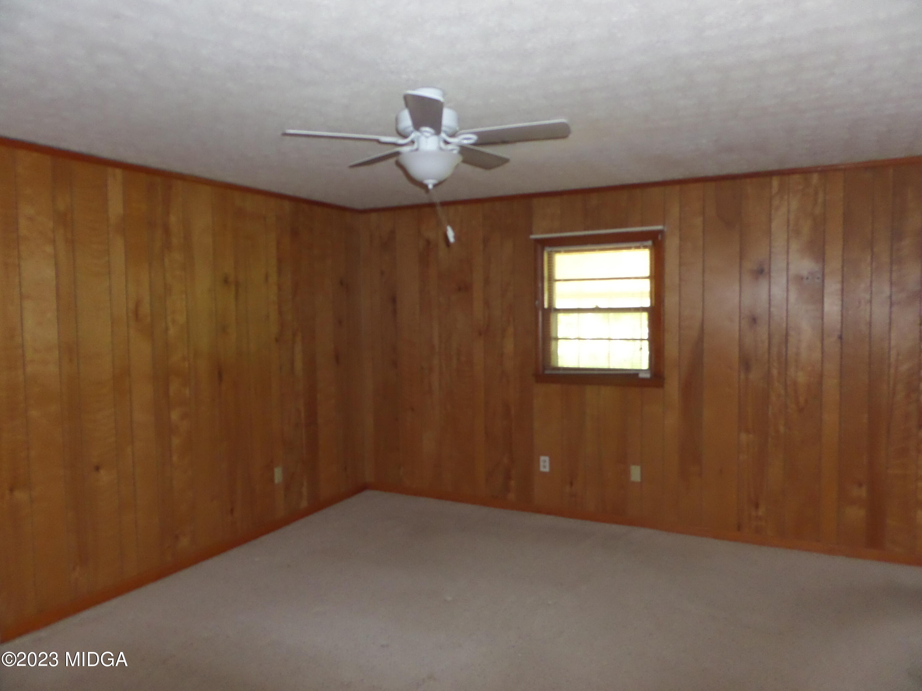 2816 Montpelier Station Road Musella, GA 31066 - Photo 7 of 9 a view of a livingroom with a ceiling fan and window