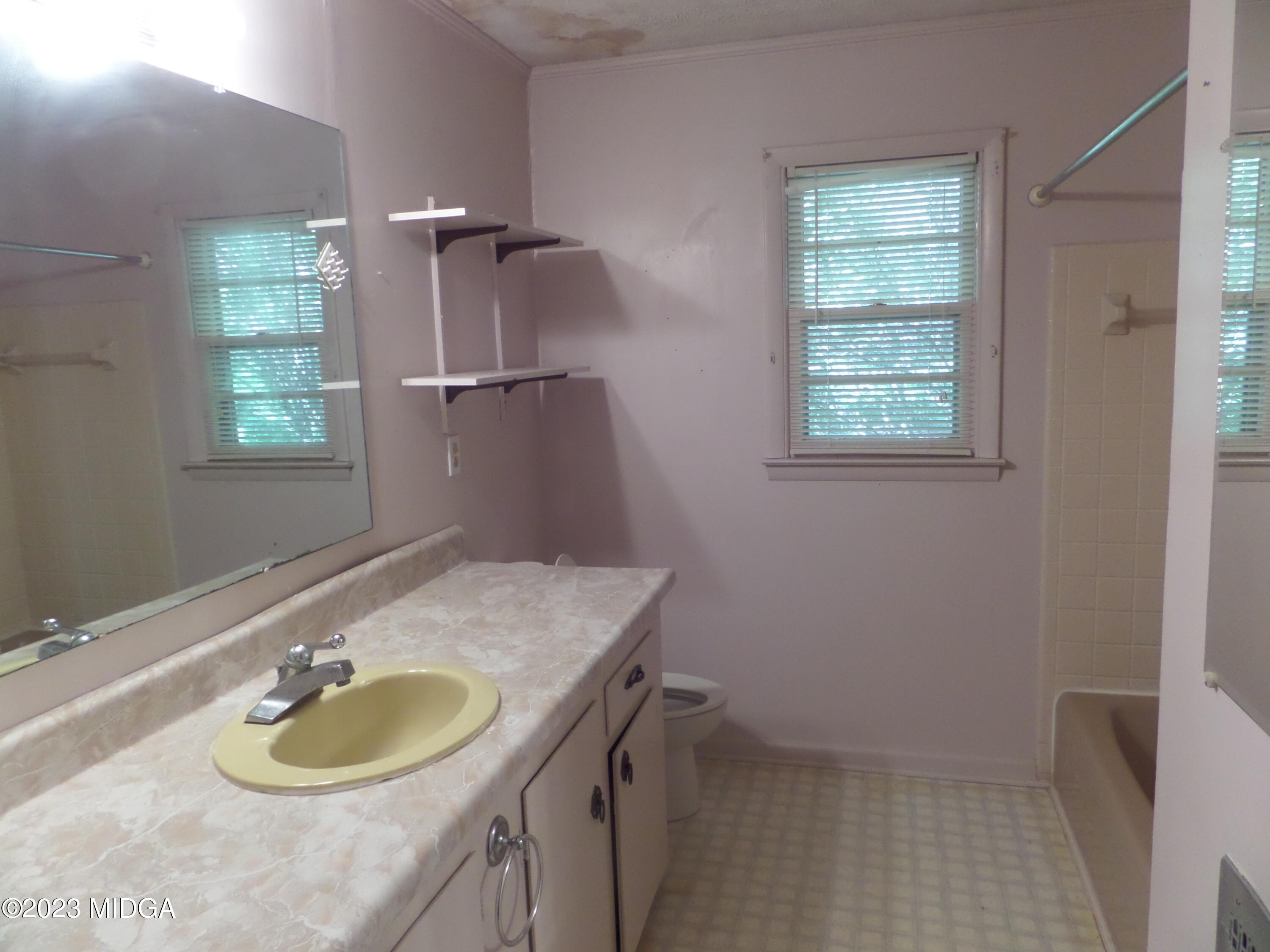 2816 Montpelier Station Road Musella, GA 31066 - Photo 8 of 9 a bathroom with a granite countertop sink and a mirror