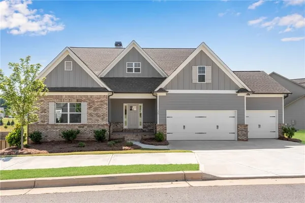 a front view of a house with a yard and garage