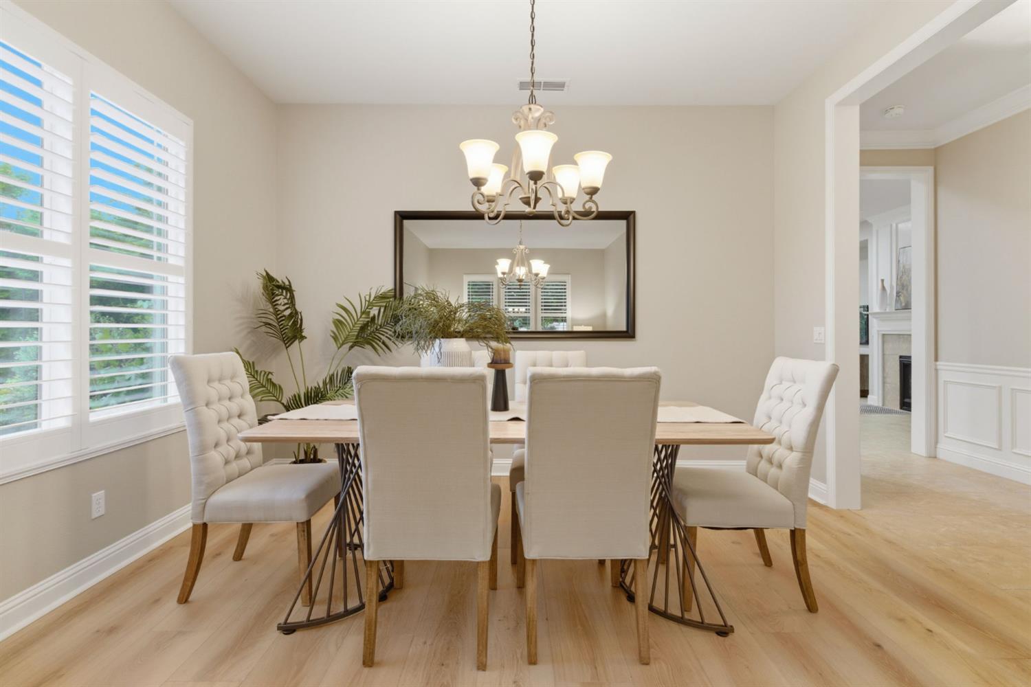 2499 Appleleaf Lane Manteca, CA 95336 - Photo 14 of 55 a view of a dining room with furniture a chandelier and wooden floor