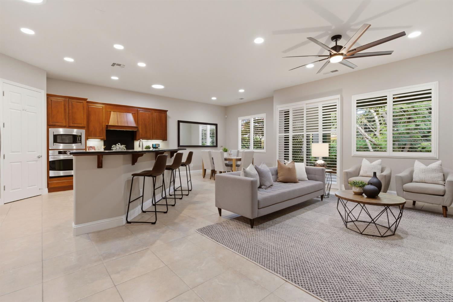 2499 Appleleaf Lane Manteca, CA 95336 - Photo 22 of 55 a living room with furniture and a large window with kitchen view