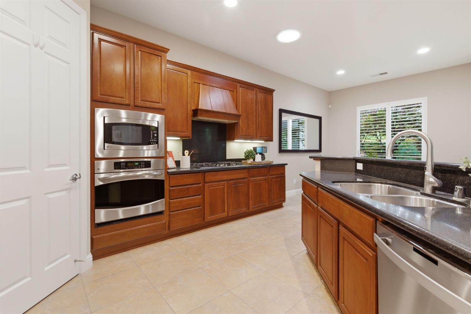 2499 Appleleaf Lane Manteca, CA 95336 - Photo 23 of 55 a kitchen with stainless steel appliances a sink stove and cabinets