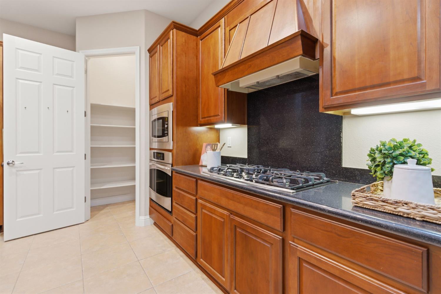 2499 Appleleaf Lane Manteca, CA 95336 - Photo 25 of 55 a kitchen with granite countertop cabinets and appliances