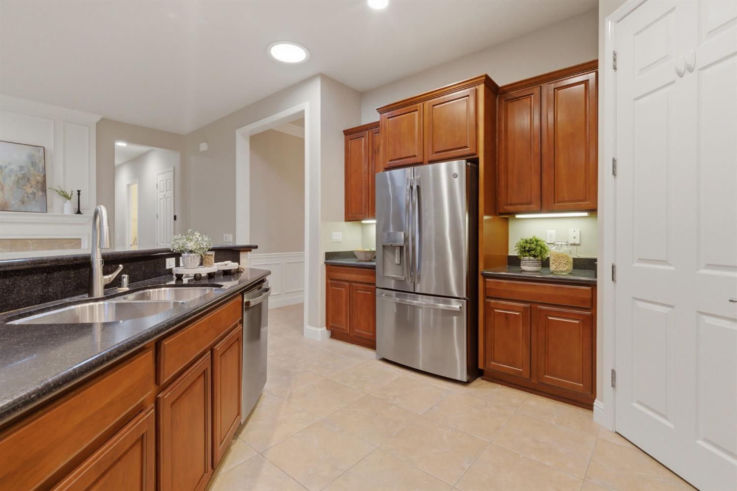 2499 Appleleaf Lane Manteca, CA 95336 - Photo 26 of 55 a kitchen with stainless steel appliances granite countertop a refrigerator a sink a stove and island