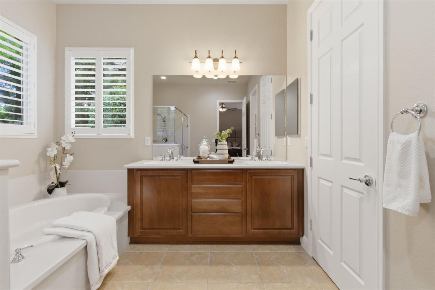 2499 Appleleaf Lane Manteca, CA 95336 - Photo 35 of 55 a bathroom with a double vanity sink mirror and bathtub