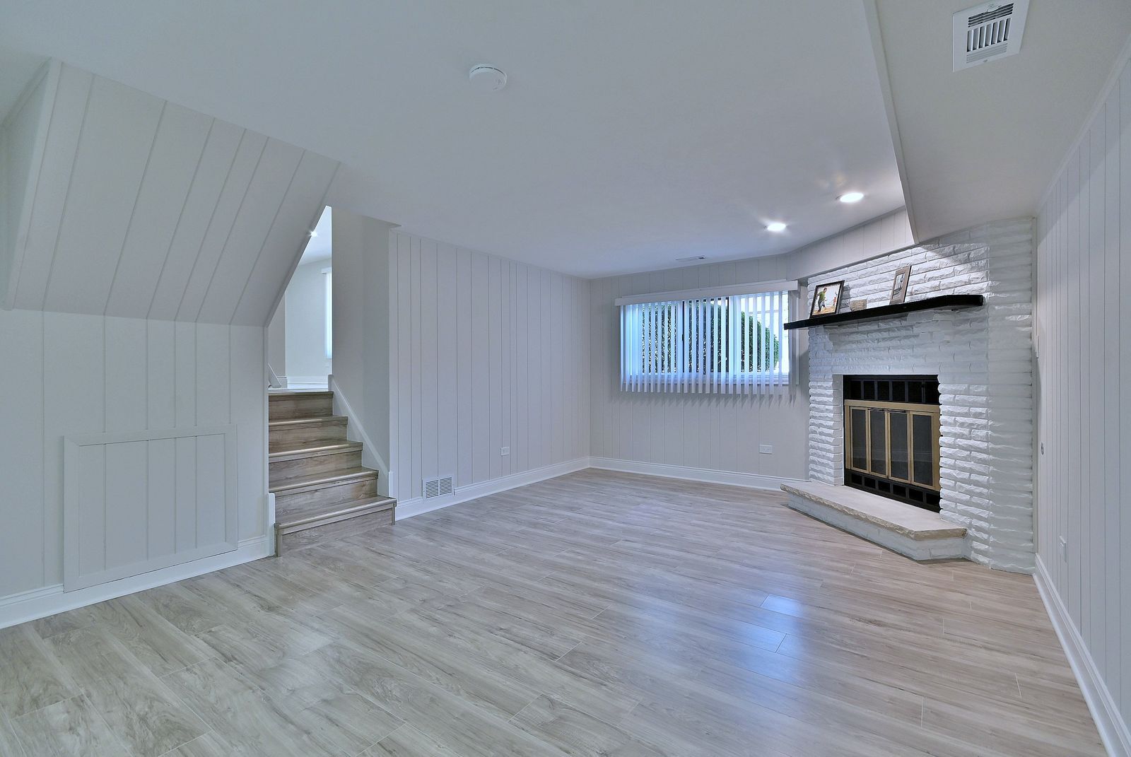 15262 74th Avenue, Unit 36 Orland Park, IL 60462 - Photo 18 of 25 an empty room with wooden floor fireplace and windows