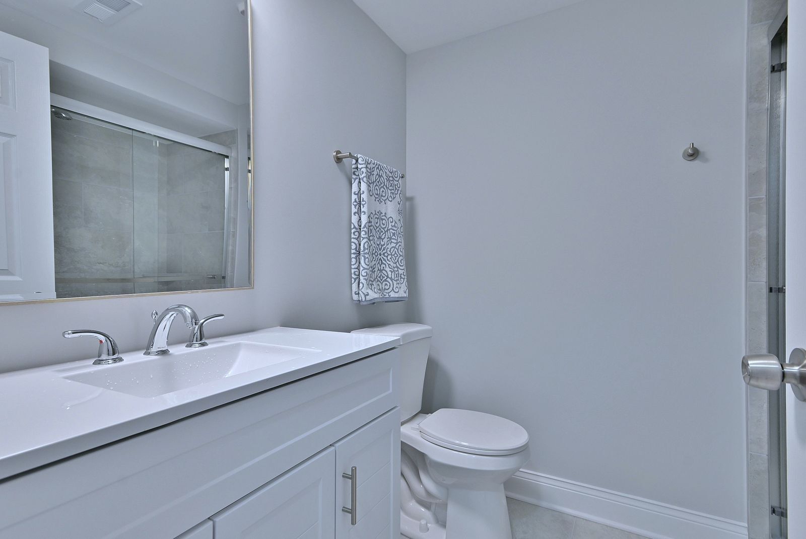 15262 74th Avenue, Unit 36 Orland Park, IL 60462 - Photo 21 of 25 a bathroom with a sink a toilet and a mirror