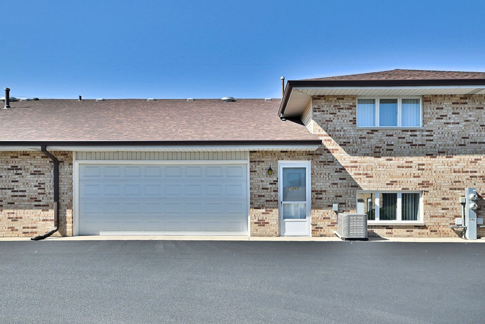 15262 74th Avenue, Unit 36 Orland Park, IL 60462 - Photo 24 of 25 a front view of a house with a garage