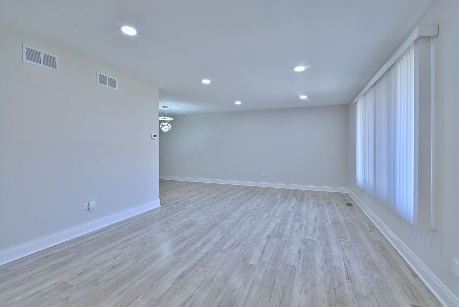15262 74th Avenue, Unit 36 Orland Park, IL 60462 - Photo 3 of 25 an empty room with wooden floor and windows