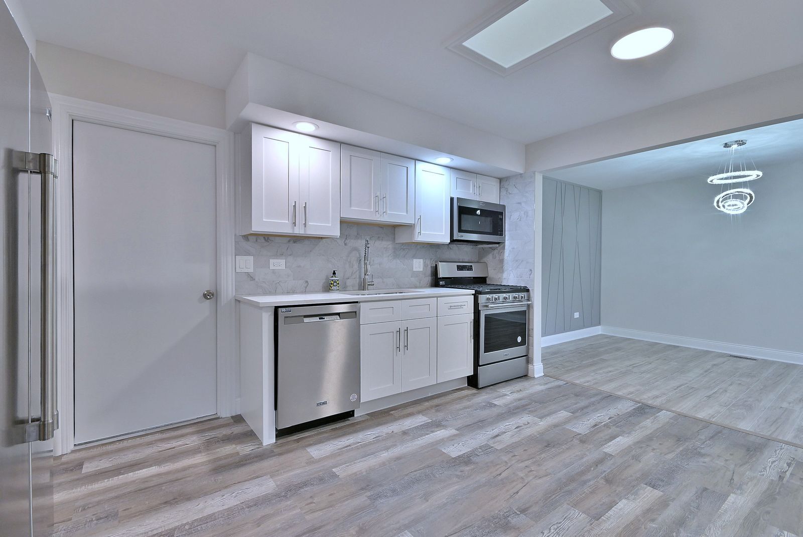 15262 74th Avenue, Unit 36 Orland Park, IL 60462 - Photo 9 of 25 a kitchen with a refrigerator stove and white cabinets