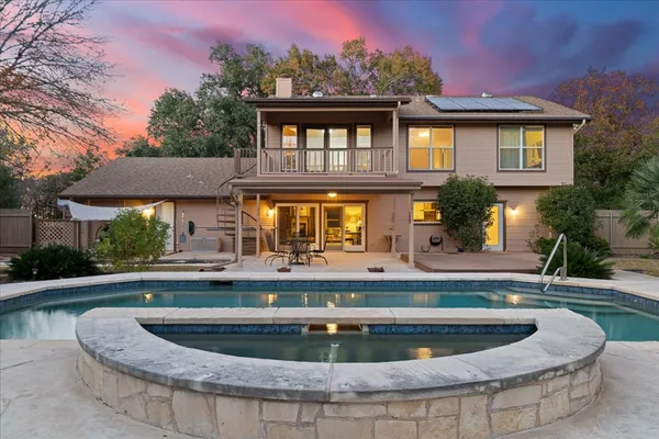 a view of a house with swimming pool and a yard