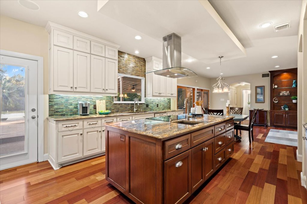 3803 Frodo Cove Austin, TX 78739 - Photo 11 of 40 a kitchen with a stove window and cabinets