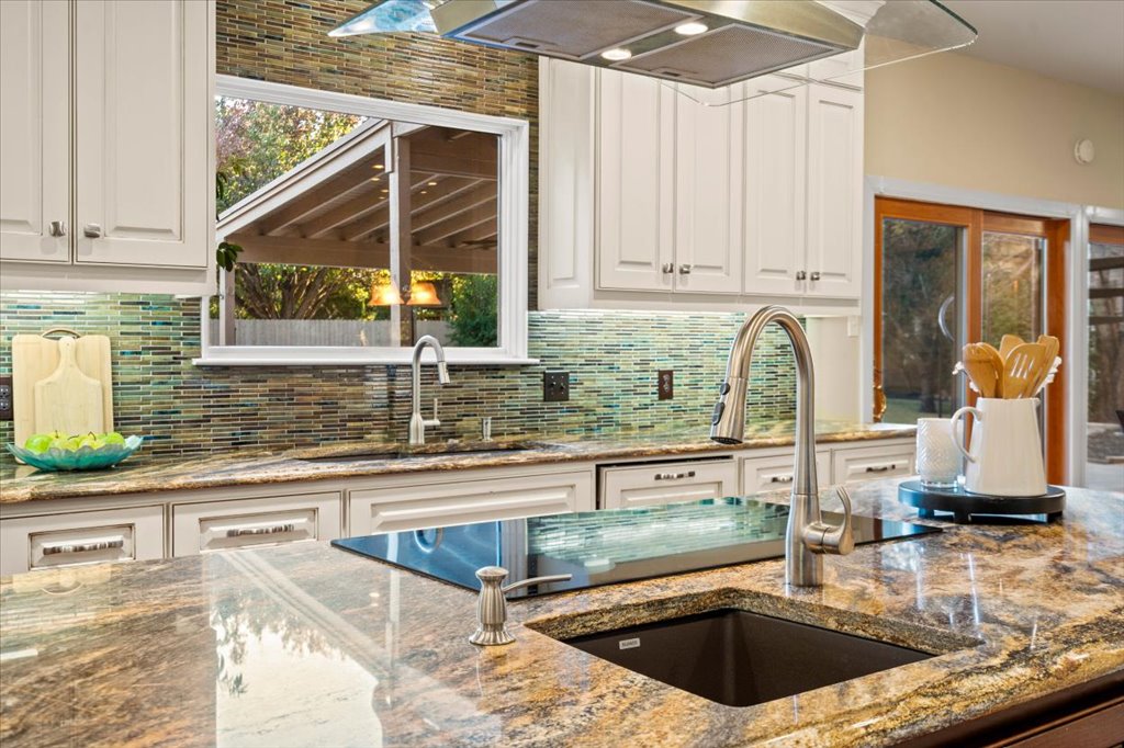 3803 Frodo Cove Austin, TX 78739 - Photo 13 of 40 a kitchen with kitchen island granite countertop a sink and a counter top space