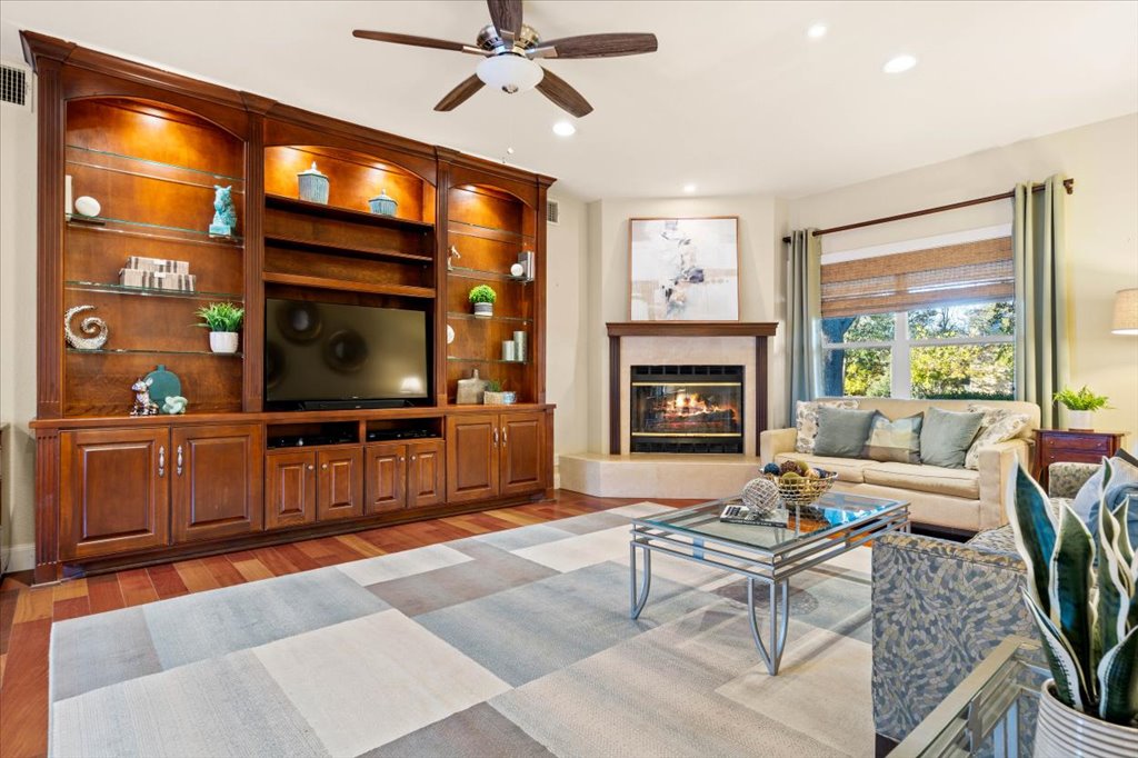 3803 Frodo Cove Austin, TX 78739 - Photo 16 of 40 a living room with furniture a flat screen tv and a fireplace